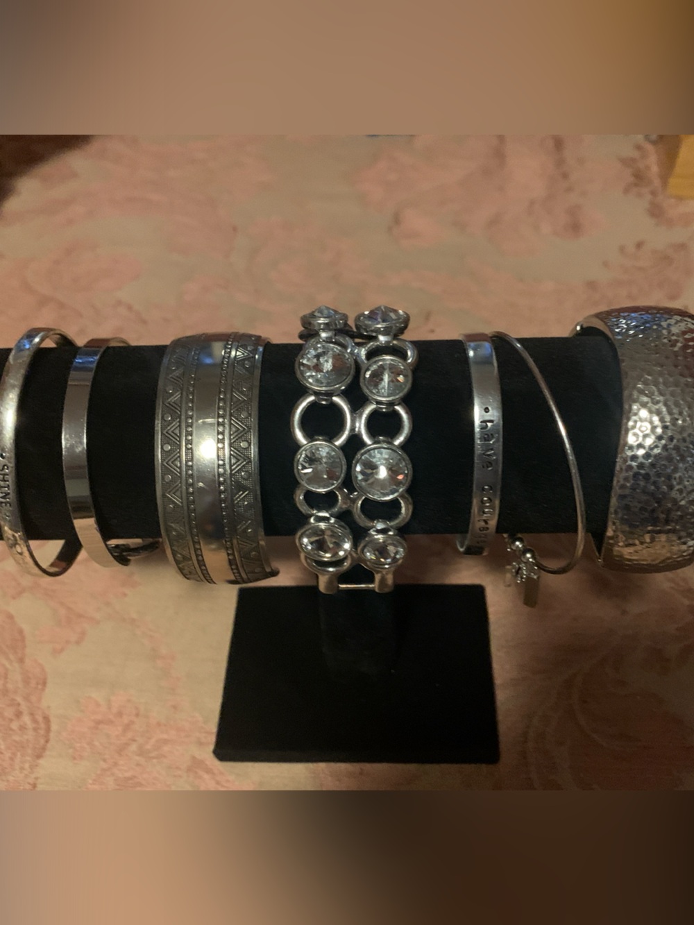 A collection of silver tone bracelets